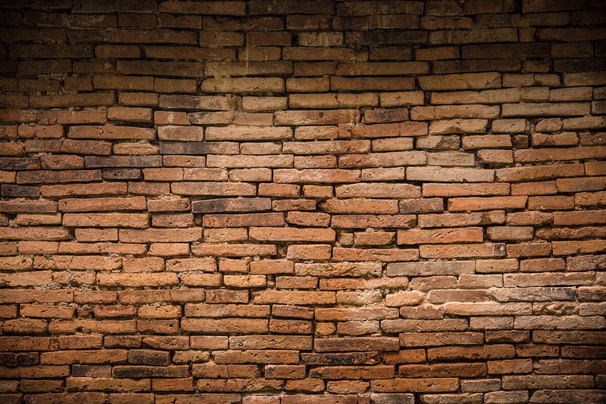 Fotobehang Een bakstenen muur die buigt