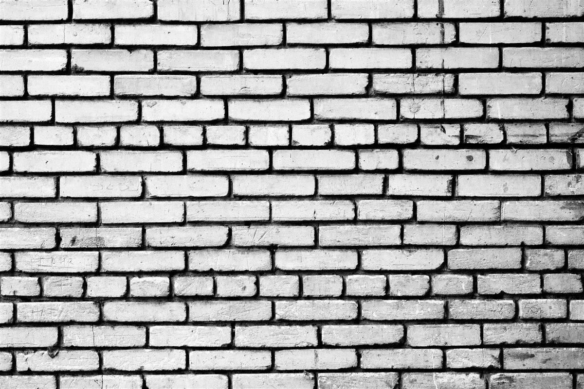 Fotobehang Muur versierd met witte bakstenen