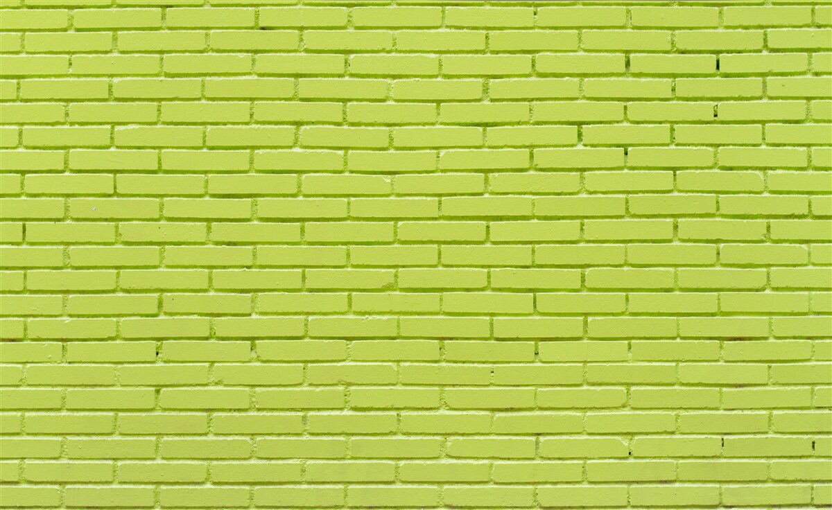 Fotobehang Bakstenen muur in lichtgroene tint