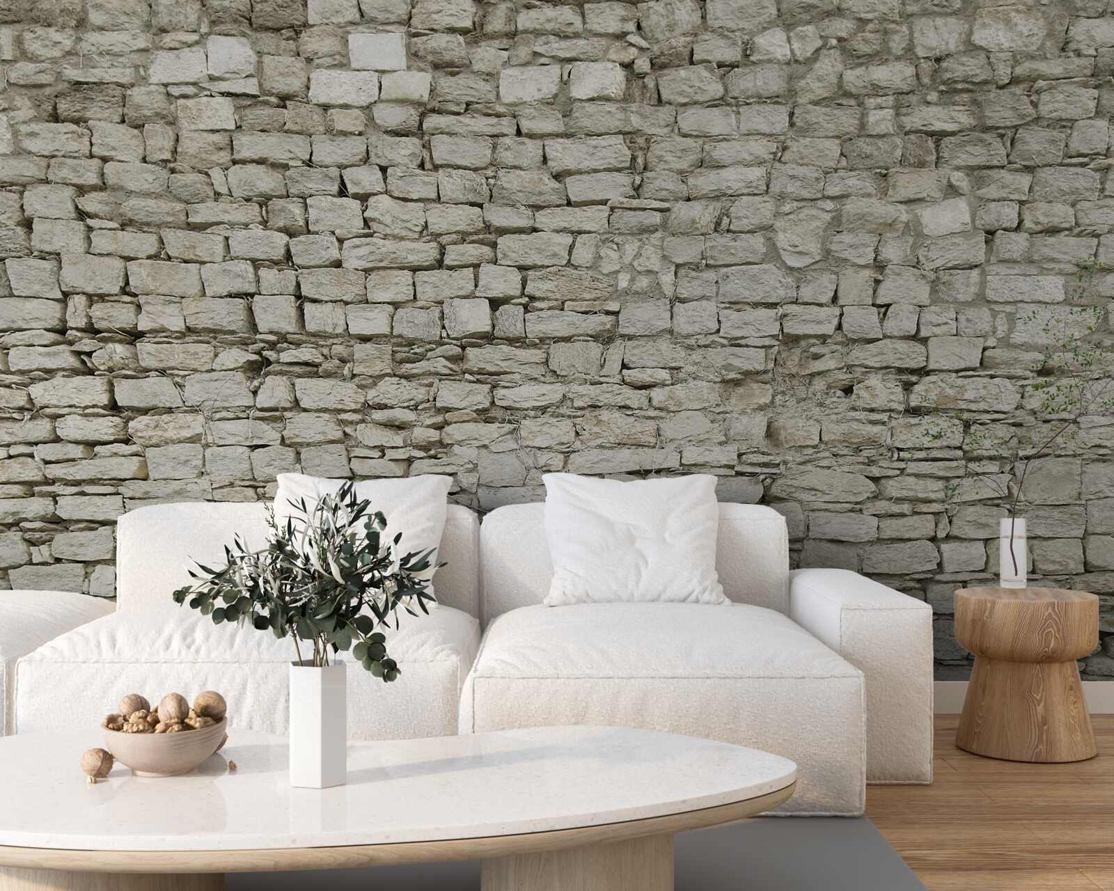 Fotobehang verspreide stenen muur leggen