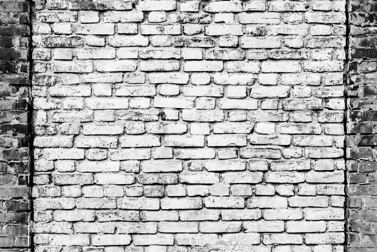 Fotobehang Bakstenen muur met krassen