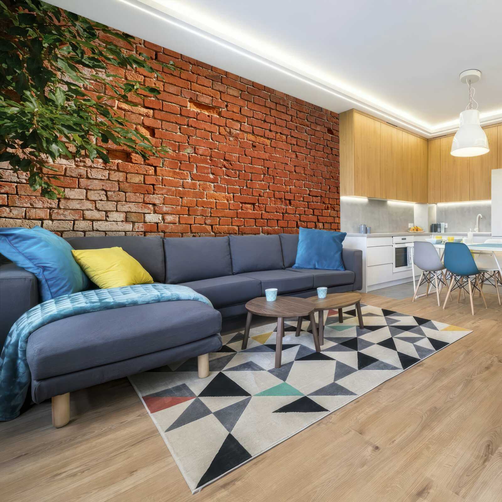 Fotobehang een houten tak naast een stenen barrière