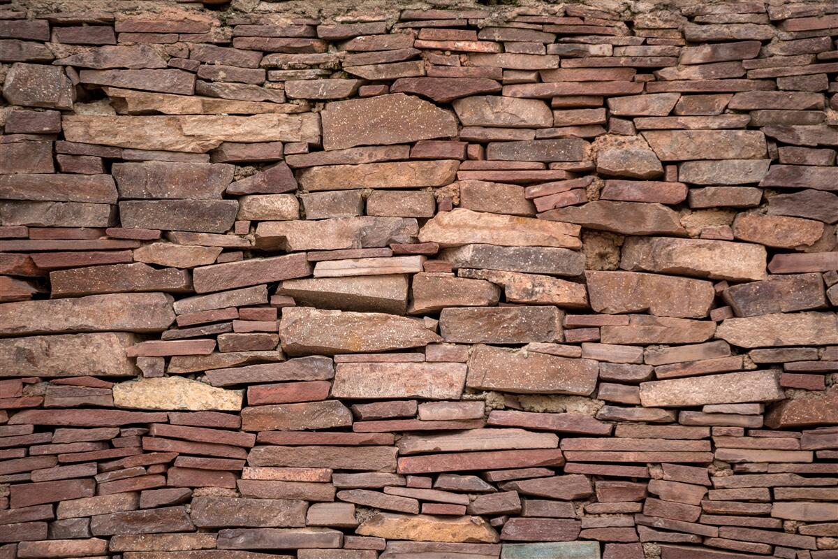Fotobehang bruine stenen barrière met ongelijke textuur