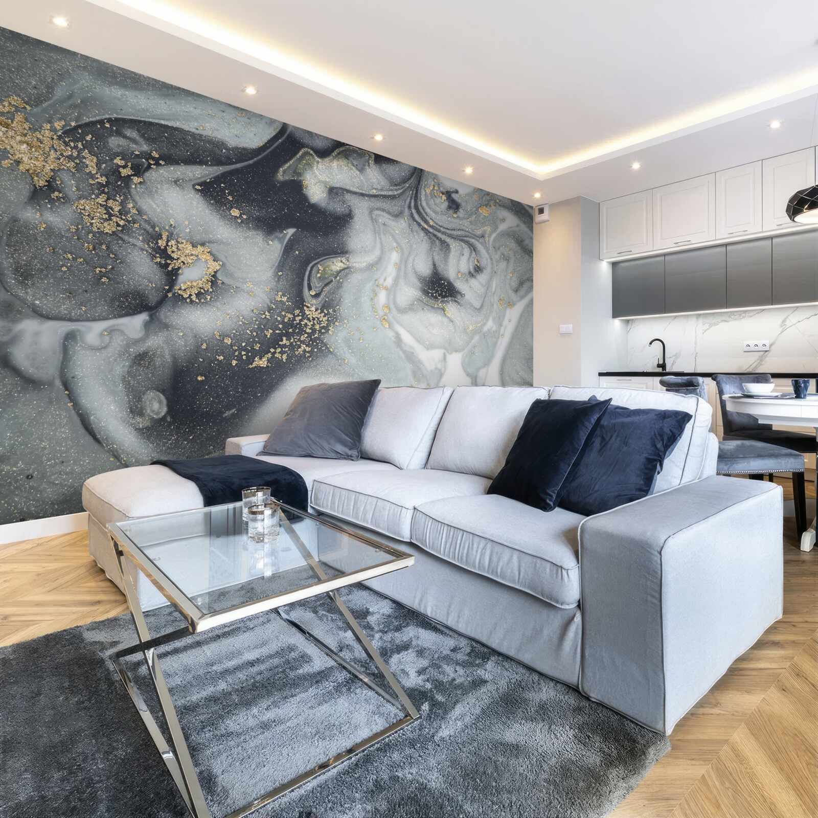 Fotobehang gouden zandkorrels op een grijs marmeren oppervlak