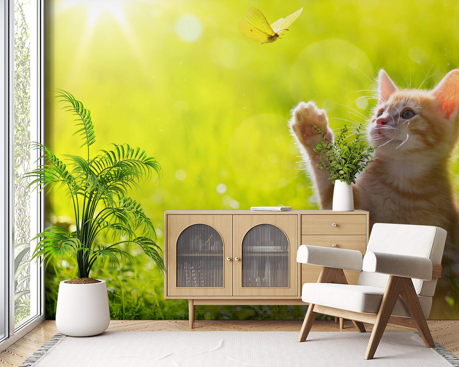 Fotobehang een kleine kat speelt met een vlinder in een groen veld