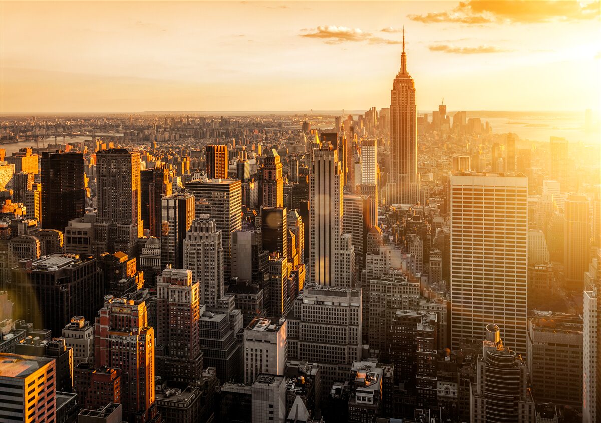 Fotobehang wolkenkrabbers van new york in het licht van de ondergaande zon