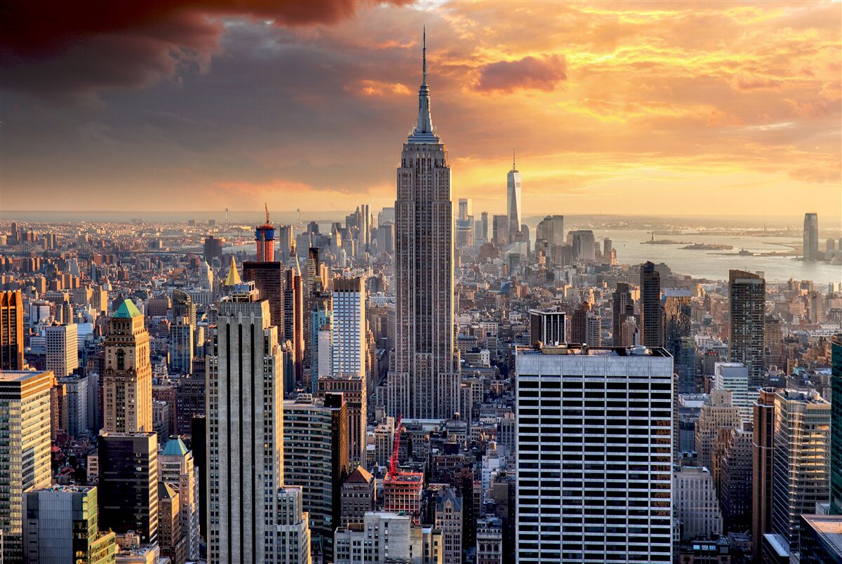 Fotobehang de zon gaat onder boven new york