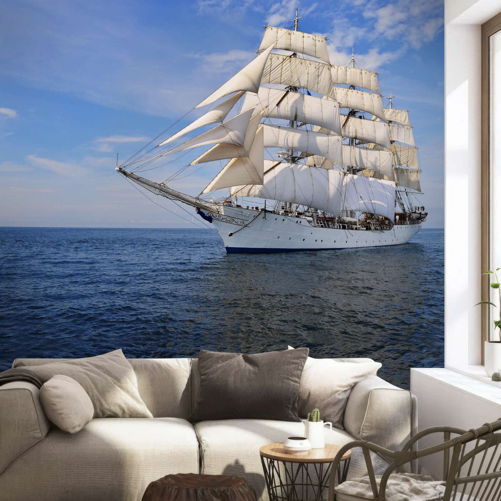 Fotobehang een schip met zeilen op een kalme zee