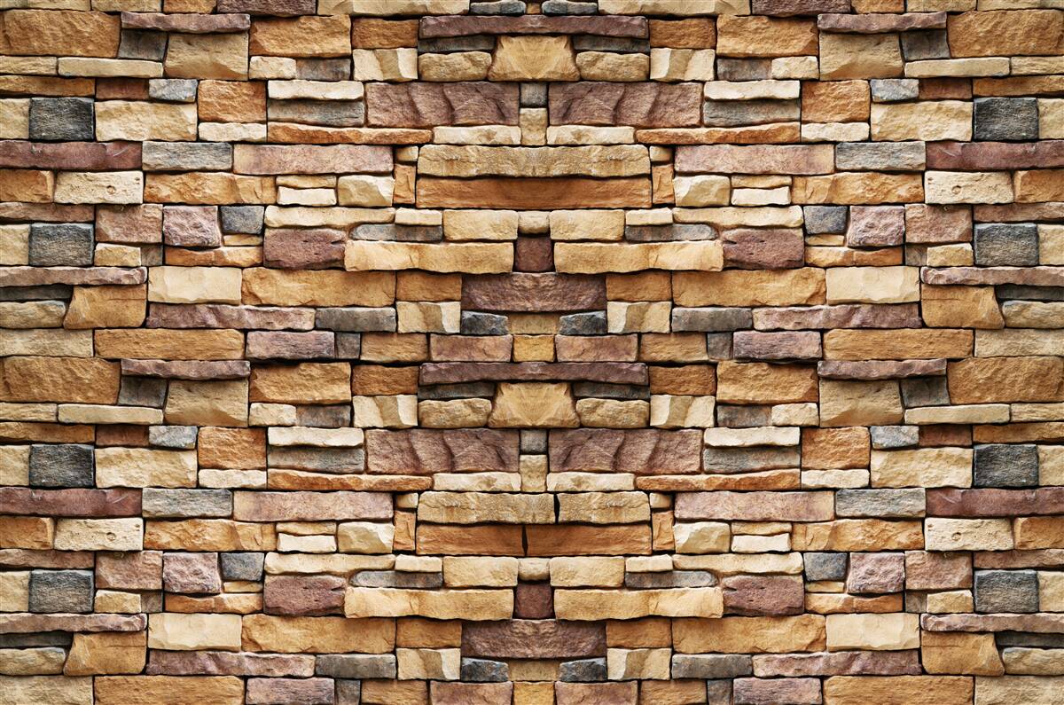 Fotobehang Een muur van veelkleurige stenen