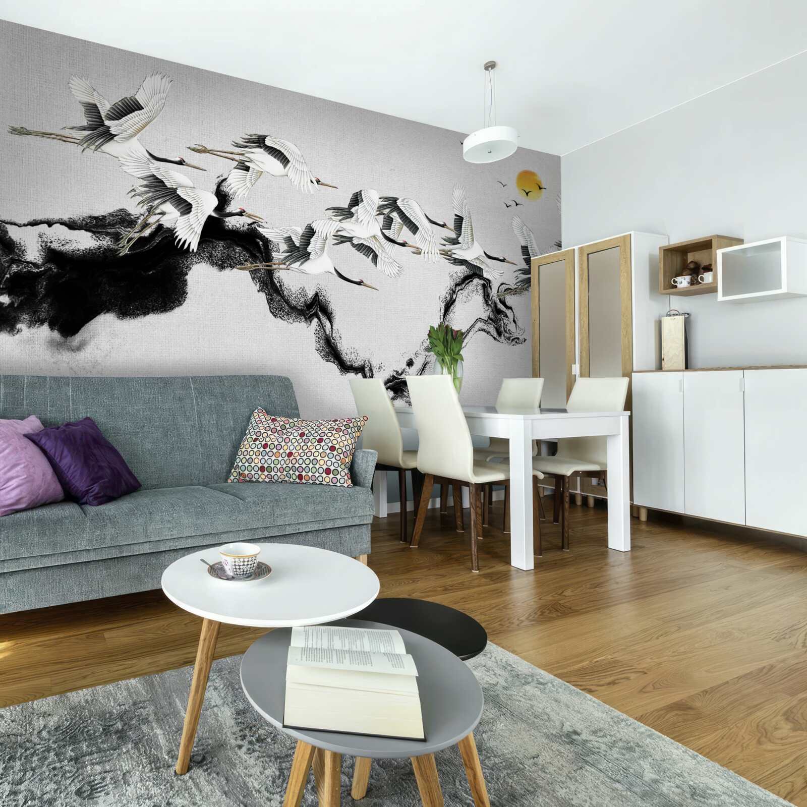 Fotobehang groep japanse kraanvogels glijdend naar de zonsondergang