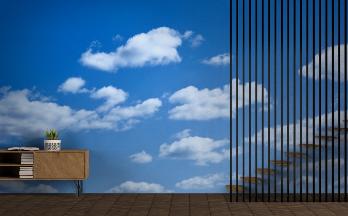 Fotobehang witte wolken drijvend in een blauwe lucht