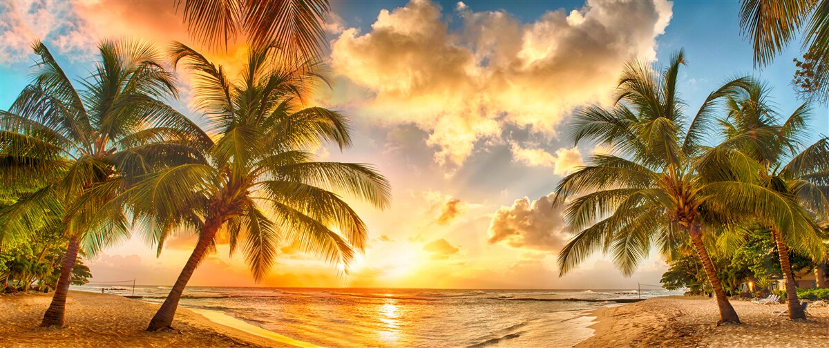 Fotobehang de zon gaat onder boven de oceaan