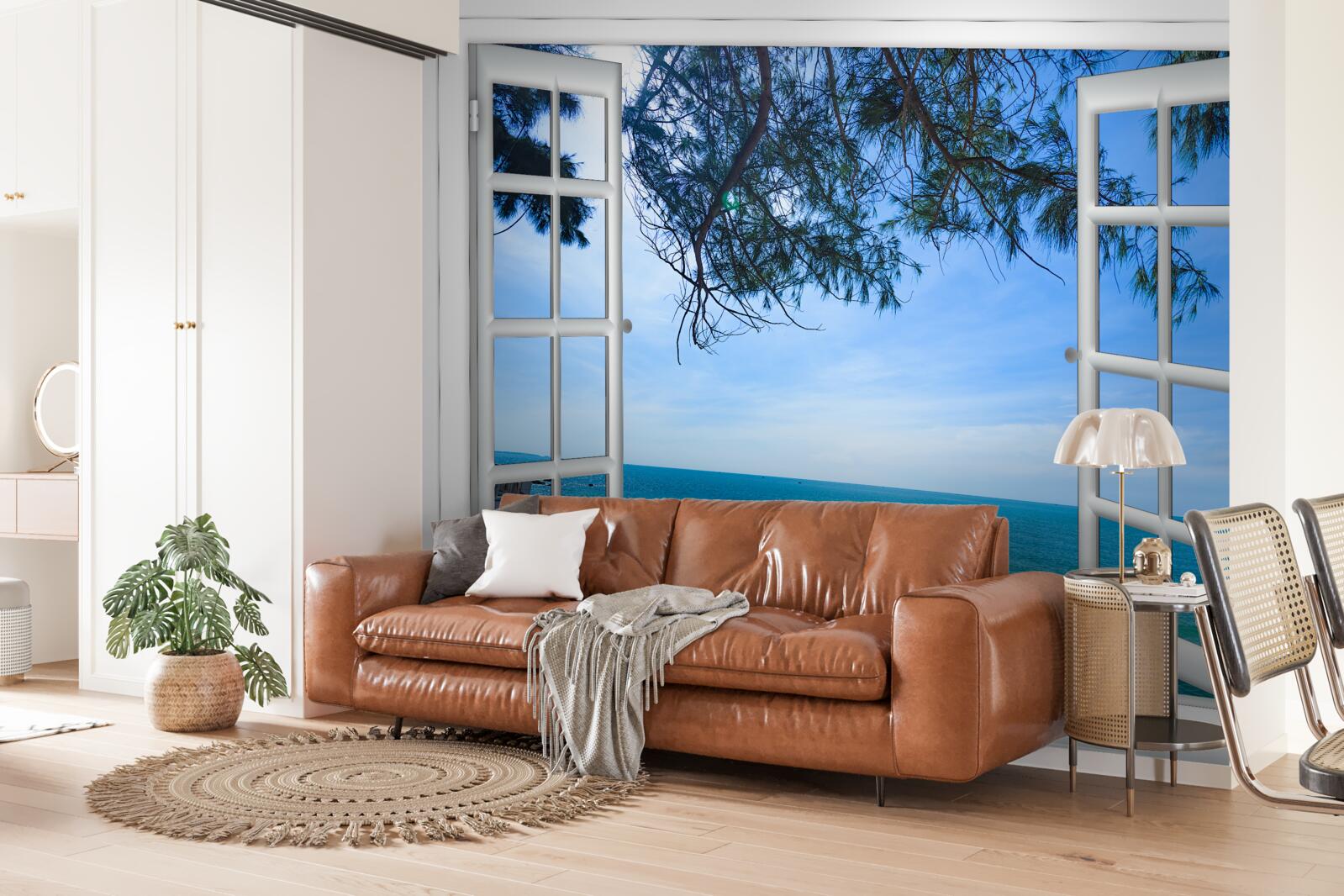 Fotobehang een raam met uitzicht op de blauwe zee